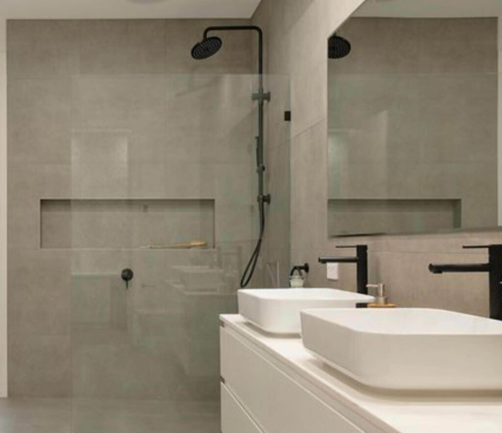 Modern, Clean looking bathroom with grey tiles and contrasting black tapware